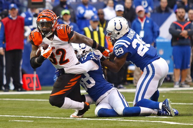 INDIANAPOLIS, IN - OCTOBER 19:  Jeremy Hill #32 of the Cincinnati Bengals is tackled by Sergio Brown #38 of the Indianapolis Colts and Mike Adams #29 of the Indianapolis Colts during the fourth quarter on October 19, 2014 at Lucas Oil Stadium on October 19, 2014 in Indianapolis, Indiana. Indianapolis defeated Cincinnati 27-0. (Photo by Kirk Irwin/Getty Images)