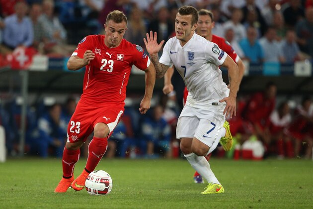 BASEL, SWITZERLAND - SEPTEMBER 08: Xherdan Shaqiri of Switzerland (L) fights for the ball with Jack Wilshere of England during the EURO 2016 Qualifier match between Switzerland and England on September 8, 2014 in Basel, Switzerland. (Photo by Philipp Schmidli/Getty Images)