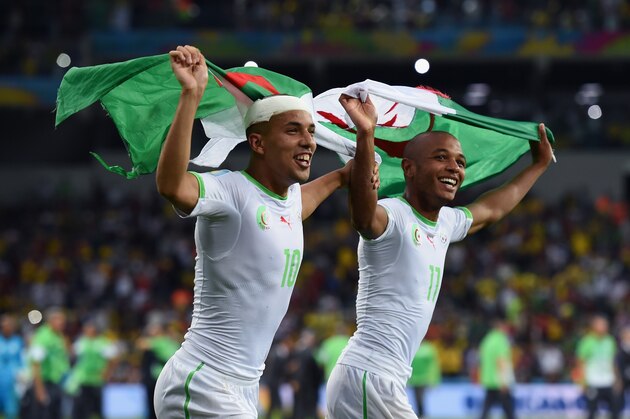 CURITIBA, BRAZIL - JUNE 26: Sofiane Feghouli (L) and Yacine Brahimi of Algeria celebrate after a 1-1 draw during the 2014 FIFA World Cup Brazil Group H match between Algeria and Russia at Arena da Baixada on June 26, 2014 in Curitiba, Brazil.  (Photo by Matthias Hangst/Getty Images)