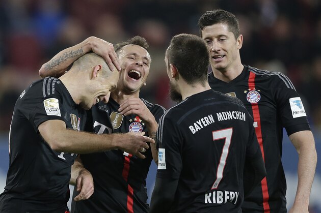 Bayern's Arjen Robben from the Netherlands, from left, celebrates with teammate Rafinha from Brazil, Franck Ribery from France and Robert Lewandowski from Poland  after scoring his side's fourth goal during the German first division Bundesliga soccer match between FC Augsburg and FC Bayern Munich in the SGL Arena in Augsburg, Germany, on Saturday, Dec. 13, 2014. (AP Photo/Matthias Schrader)