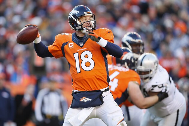 Denver Broncos quarterback Peyton Manning (18) throws against the Oakland Raiders during the first half of an NFL football game, Sunday, Dec. 28, 2014, in Denver. (AP Photo/Joe Mahoney)
