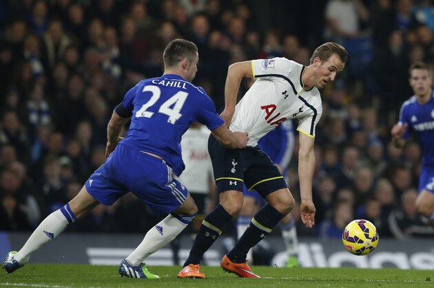 Chelsea's John Terry, left, challenges Tottenham’s Harry Kane for the ball during the English Premier League soccer match between Chelsea and Tottenham Hotspur at Stamford Bridge stadium in London, Wednesday, Dec.  3,  2014. (AP Photo/Alastair Grant)