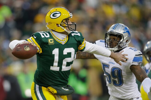 GREEN BAY, WI - DECEMBER 28:  Quarterback Aaron Rodgers #12 of the Green Bay Packers looks to pass against middle linebacker Tahir Whitehead #59 of the Detroit Lions in the second half of the NFL game at Lambeau Field on December 28, 2014 in Green Bay, Wisconsin.  (Photo by Mike McGinnis/Getty Images)