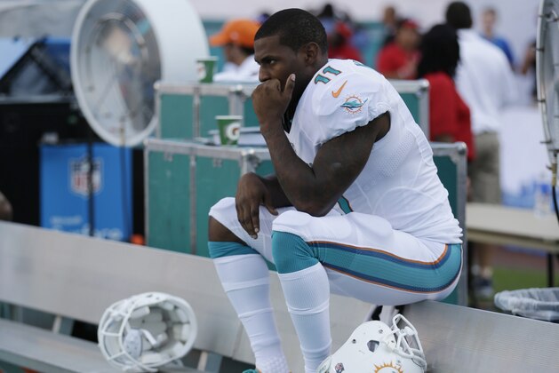Miami Dolphins wide receiver Mike Wallace (11) sits on the bench during the second half of an NFL football game against the New York Jets, Sunday, Dec. 28, 2014, in Miami Gardens, Fla. The Jets defeated the Dolphins 37-24. (AP Photo/Wilfredo Lee)