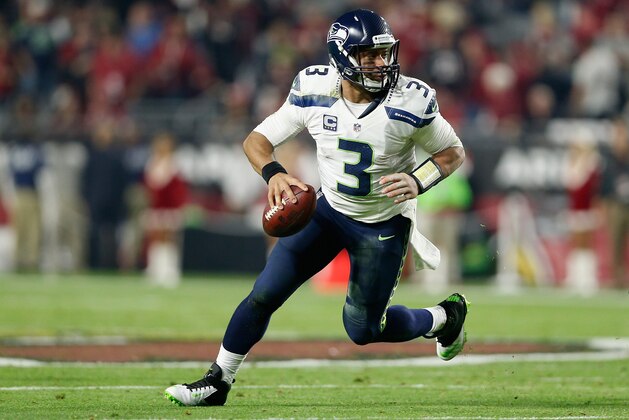 GLENDALE, AZ - DECEMBER 21:  Quarterback Russell Wilson #3 of the Seattle Seahawks scrambles with the football during the NFL game against the Arizona Cardinals at the University of Phoenix Stadium on December 21, 2014 in Glendale, Arizona.  The Seahawks defeated the Cardinals 35-6.  (Photo by Christian Petersen/Getty Images)