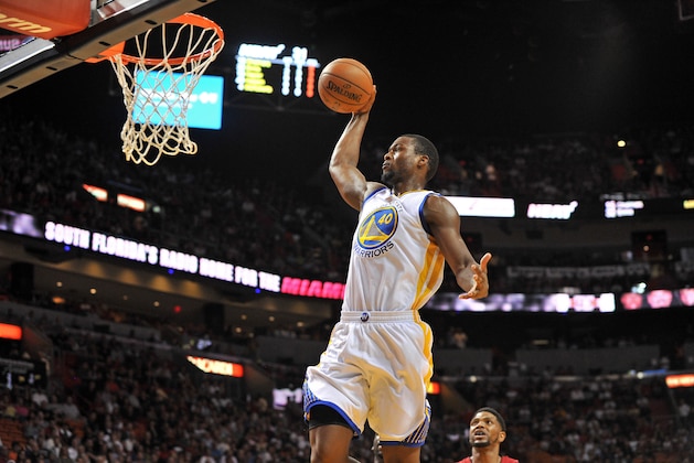 Nov 25, 2014; Miami, FL, USA; Golden State Warriors forward Harrison Barnes (40) dunks the ball as Miami Heat forward Udonis Haslem (40) looks on during the first half at American Airlines Arena. Mandatory Credit: Steve Mitchell-USA TODAY Sports