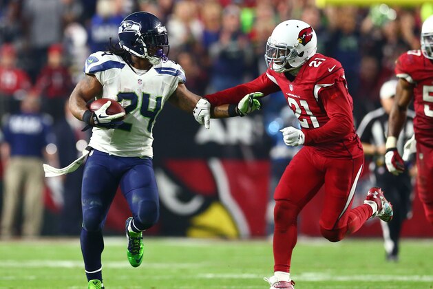 Dec 21, 2014; Glendale, AZ, USA; Seattle Seahawks running back Marshawn Lynch (24) is pursued by Arizona Cardinals cornerback Patrick Peterson (21) as he runs for a 79 yard touchdown in the fourth quarter at University of Phoenix Stadium. The Seahawks defeated the Cardinals 35-6. Mandatory Credit: Mark J. Rebilas-USA TODAY Sports