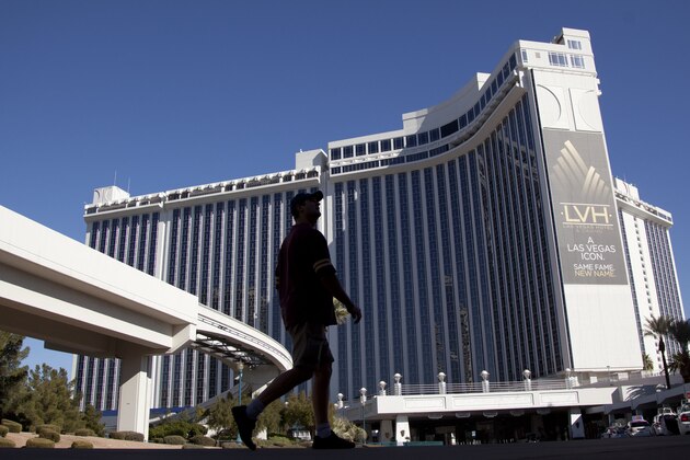 A hotel guest walks around the grounds of the Las Vegas Hotel and Casino Tuesday, Jan. 3, 2012, in Las Vegas. The Las Vegas Hilton hotel-casino is no longer affiliated with the Hilton following a name change to take the chain's brand off the building. (AP Photo/Julie Jacobson)