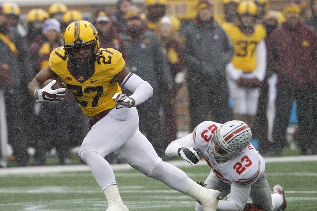 Minnesota running back David Cobb (27) leaves behind Ohio State safety Tyvis Powell on a 30-yard touchdown during the second quarter of an NCAA college football game in Minneapolis Saturday, Nov. 15, 2014. (AP Photo/Ann Heisenfelt)