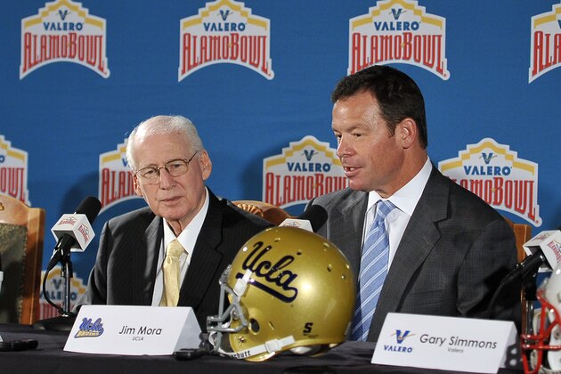 UCLA coach Jim Mora, right, and Kansas State coach Bill Snyder, speak during a press conference held to introduce the 2015 Valero Alamo Bowl college football head coaches, Thursday, Dec. 11, 2014, in San Antonio. (AP Photo/Darren Abate)