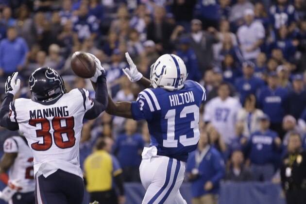 Houston Texans strong safety Danieal Manning, left, breaks up a pass to Indianapolis Colts wide receiver T.Y. Hilton during the first half of an NFL football game in Indianapolis, Sunday, Dec. 14, 2014. (AP Photo/AJ Mast)