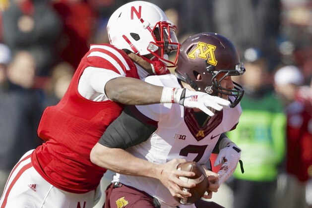 Nebraska defensive end Randy Gregory, left, sacks Minnesota quarterback Mitch Leidner (7) during the first half of an NCAA college football game in Lincoln, Neb., Saturday, Nov. 22, 2014. (AP Photo/Nati Harnik)