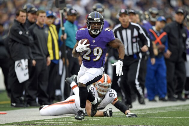 Baltimore Ravens running back Justin Forsett (29) rushes the ball past Cleveland Browns outside linebacker Paul Kruger in the first half of an NFL football game, Sunday, Dec. 28, 2014, in Baltimore. (AP Photo/Nick Wass)