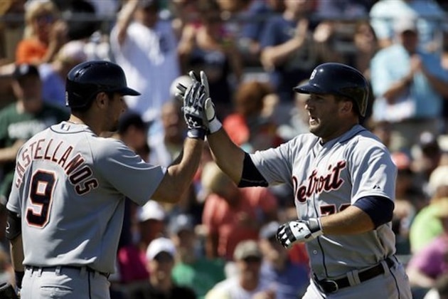 Detroit Tigers' Tyler Collins, right, high-fives teammate Nick Castellanos after hitting a home run in the seventh inning of an exhibition spring training baseball game against the Miami Marlins, Sunday, March 9, 2014, in Jupiter, Fla. (AP Photo/David Goldman)