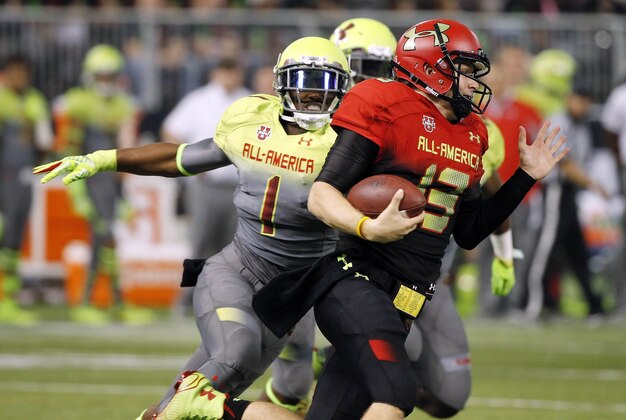 Jan 2, 2014; St. Petersburg, FL, USA; Team Highlight quarterback Sean White (13) runs with the ball as Team Nitro safety Ronnie Clark (1) rushes during the first half in the Under Armour All America football game at Tropicana Field. Mandatory Credit: Kim Klement-USA TODAY Sports