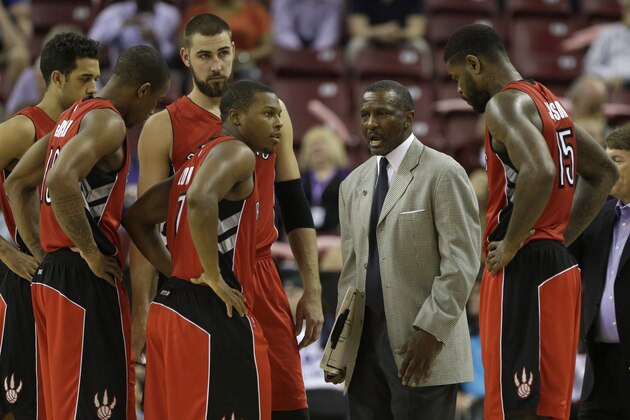 Toronto Raptors head coach Dwane Casey huddles with his team during a timeout in an NBA preseason basketball game against the Sacramento Kings in Sacramento, Calif., Tuesday, Oct. 7, 2014. The Kings won 113-106. Also seen, from left are Landry Fields, DeMar DeRozan, Jonas Valanciunas, of Lithuania, Kyle Lowry and Amir Johnson, right. (AP Photo/Rich Pedroncelli)