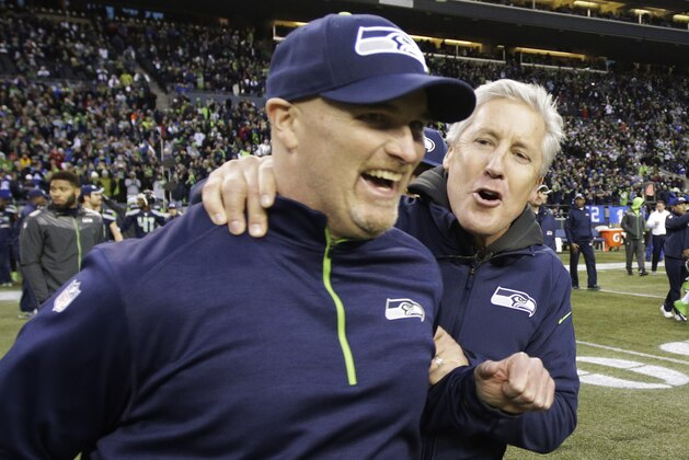 Seattle Seahawks head coach Pete Carroll, right, celebrates with defensive coordinator Dan Quinn, left, after they defeated the St. Louis Rams 20-6 in an NFL football game, Sunday, Dec. 28, 2014, in Seattle. (AP Photo/Scott Eklund)