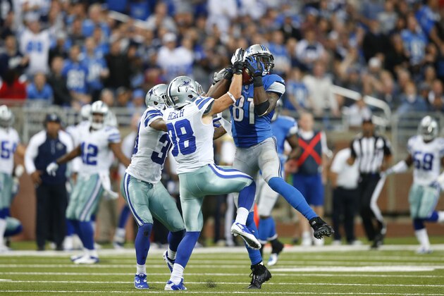 Detroit Lions wide receiver Calvin Johnson (81) catches a 54-yard reception against Dallas Cowboys cornerback Brandon Carr (39) and defensive back Jeff Heath (38) in the fourth quarter of an NFL football game in Detroit, Sunday, Oct. 27, 2013. (AP Photo/Rick Osentoski)