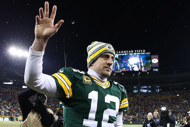 GREEN BAY, WI - DECEMBER 28:  Aaron Rodgers #12 of the Green Bay Packers waves to fans as he walks off of the field after defeating the Detroit Lions 30 to 20 to take the NFC North Championship at Lambeau Field on December 28, 2014 in Green Bay, Wisconsin.  (Photo by Chris Graythen/Getty Images)