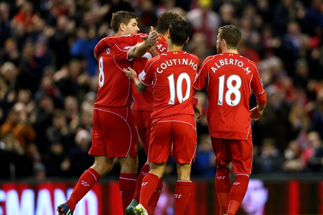 LIVERPOOL, ENGLAND - JANUARY 01:  Steven Gerrard of Liverpool is congratulated by teammates Lucas Leiva, Philippe Coutinho and Alberto Moreno of Liverpool after scoring the opening goal from the penalty spot during the Barclays Premier League match between Liverpool and Leicester City at Anfield on January 1, 2015 in Liverpool, England.  (Photo by Clive Brunskill/Getty Images)