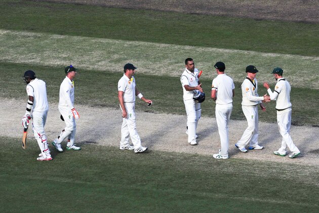 MELBOURNE, AUSTRALIA - DECEMBER 30: MS Dhoni of India shakes hands with the Australian players after the match ended in a draw during day five of the Third Test match between Australia and India at Melbourne Cricket Ground on December 30, 2014 in Melbourne, Australia.  (Photo by Vince Caligiuri/Getty Images)