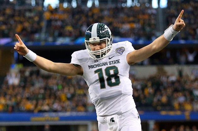 ARLINGTON, TX - JANUARY 01:  Connor Cook #18 of the Michigan State Spartans celebrates after the Spartans score a touchdown against the Baylor Bears during the first half of the Goodyear Cotton Bowl Classic at AT&T Stadium on January 1, 2015 in Arlington, Texas.  (Photo by Ronald Martinez/Getty Images)