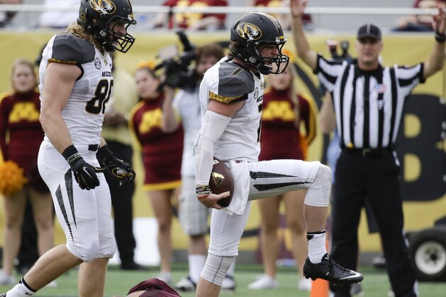 Missouri quarterback Maty Mauk (7) celebrates after running 18-yards for a touchdown against Minnesota during the second half of the Citrus Bowl NCAA college football game in Orlando, Fla., Thursday, Jan. 1, 2015. Missouri won 33-17. (AP Photo/John Raoux)
