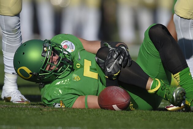 Oregon wide receiver Devon Allen holds his knee after being injured during the first half of the Rose Bowl NCAA college football playoff semifinal against Florida State, Thursday, Jan. 1, 2015, in Pasadena, Calif. (AP Photo/Mark J. Terrill)