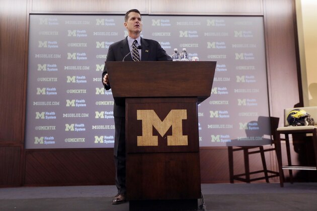Jim Harbaugh, Michigan's new head football coach, addresses the media after after he was introduced during an NCAA college football news conference Tuesday, Dec. 30, 2014, in Ann Arbor, Mich. (AP Photo/Carlos Osorio)
