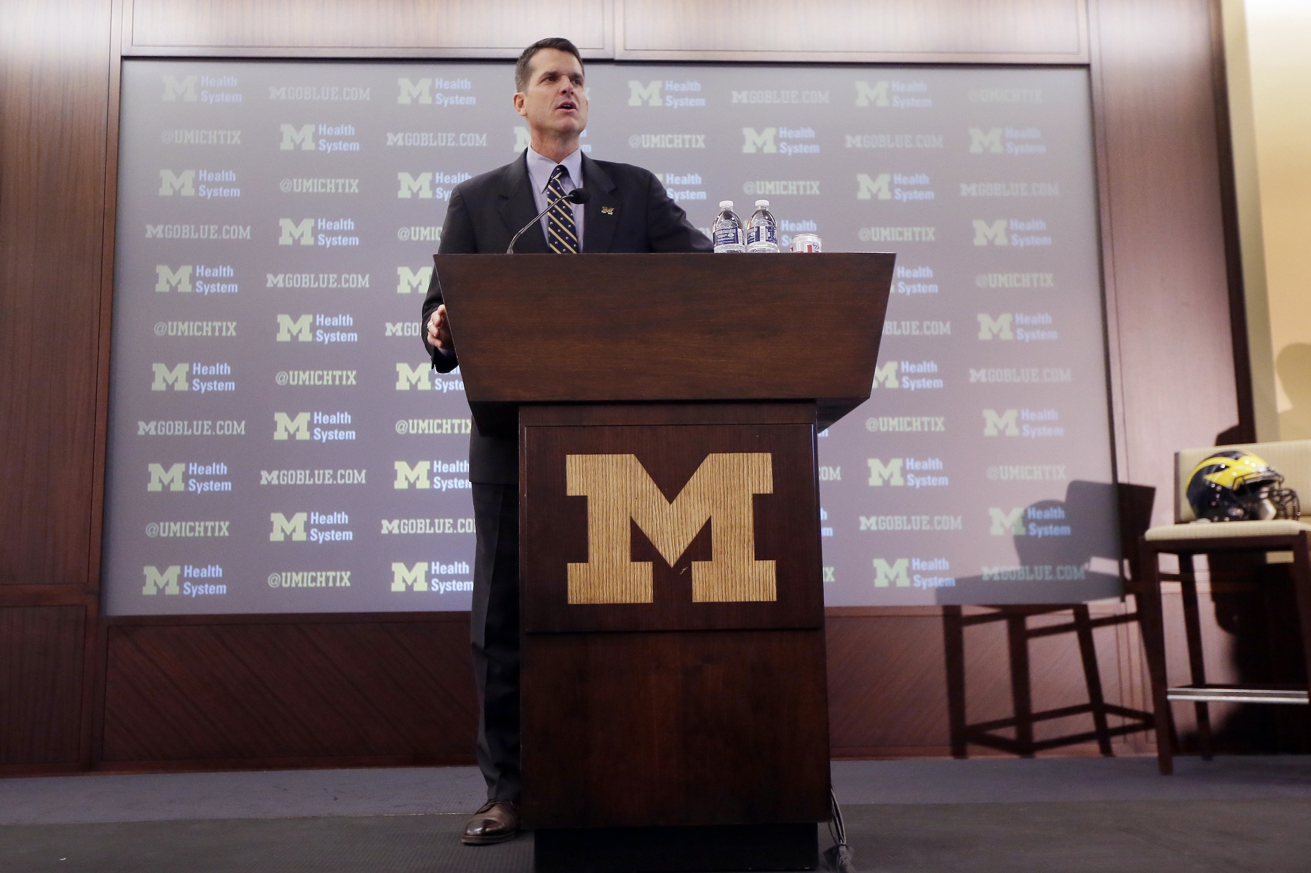 Jim Harbaugh, Michigan's new head football coach, addresses the media after after he was introduced during an NCAA college football news conference Tuesday, Dec. 30, 2014, in Ann Arbor, Mich. (AP Photo/Carlos Osorio)