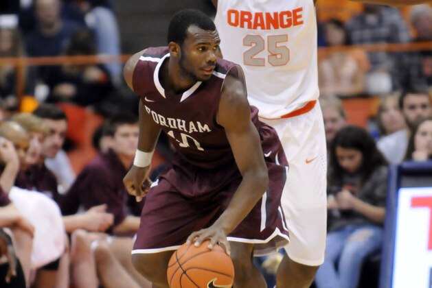 Nov 12, 2013; Syracuse, NY, USA; Fordham Rams guard Jon Severe (10) is defended by Syracuse Orange forward Rakeem Christmas (25) during the second half of a game at the  Carrier Dome. Syracuse won the game  89-74. Mandatory Credit: Mark Konezny-USA TODAY Sports