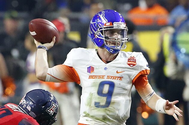 Boise State's Grant Hedrick (9) gets off a pass as he is pressured by Arizona's Cody Ippolito, left, during the first half of the Fiesta Bowl NCAA college football game Wednesday, Dec. 31, 2014, in Glendale, Ariz. (AP Photo/Ross D. Franklin)