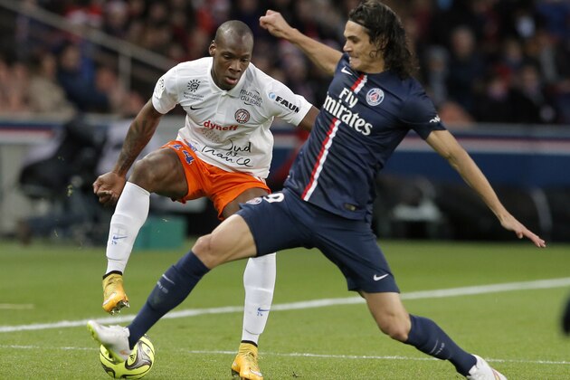 Montpellier’s Bryan Dabo, left, vies for the ball with Paris Saint Germain's Edinson Cavani, during the League One soccer match between Paris Saint Germain and Montpellier,  at Parc des Princes stadium, in Paris, Saturday, Dec. 20, 2014. (AP Photo/Francois Mori)
