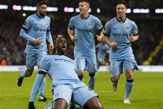 Manchester City's Yaya Toure, bottom, celebrates after scoring against Sunderland during the English Premier League soccer match between Manchester City and Sunderland at the Etihad Stadium, Manchester, England, Thursday Jan. 1, 2015. (AP Photo/Jon Super)