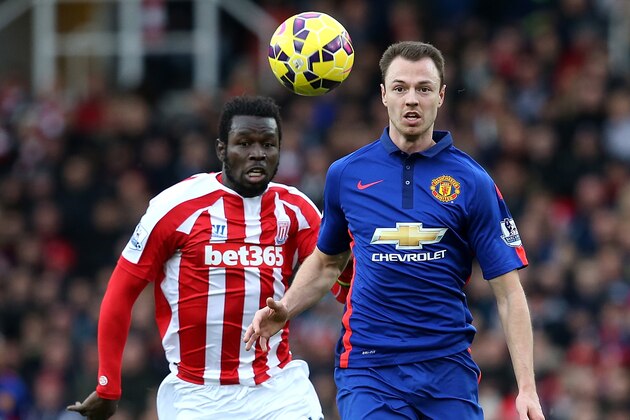 STOKE ON TRENT, ENGLAND - JANUARY 01:  Jonny Evans of Manchester United competes with Mame Diouf of Stoke City during the Barclays Premier League match between Stoke City and Manchester United at Britannia Stadium on January 1, 2015 in Stoke on Trent, England.  (Photo by Jan Kruger/Getty Images)