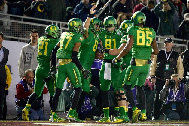 PASADENA, CA - JANUARY 01: Quarterback Marcus Mariota #8 of the Oregon Ducks celebrates after scoring on a 23-yard touchdown run in the fourth quarter of the College Football Playoff Semifinal at the Rose Bowl Game presented by Northwestern Mutual at the Rose Bowl on January 1, 2015 in Pasadena, California. (Photo by Harry How/Getty Images) PASADENA, CA - JANUARY 01: Quarterback Marcus Mariota #8 of the Oregon Ducks celebrates after scoring on a 23-yard touchdown run in the fourth quarter of the College Football Playoff Semifinal at the Rose Bowl Game presented by Northwestern Mutual at the Rose Bowl on January 1, 2015 in Pasadena, California. (Photo by Harry How/Getty Images)