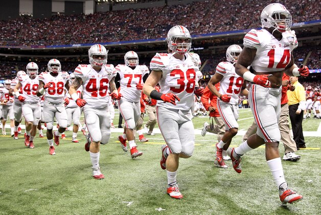 NEW ORLEANS, LA - JANUARY 01:  Ohio State Buckeye players run onto the field at the start of the game during the All State Sugar Bowl at the Mercedes-Benz Superdome on January 1, 2015 in New Orleans, Louisiana.  (Photo by Streeter Lecka/Getty Images)