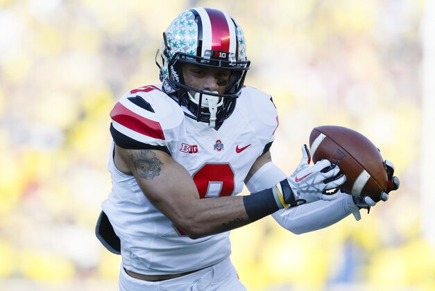 Nov 30, 2013; Ann Arbor, MI, USA; Ohio State Buckeyes wide receiver Devin Smith (9) makes a touchdown reception in the first quarter against the Michigan Wolverines at Michigan Stadium. Mandatory Credit: Rick Osentoski-USA TODAY Sports