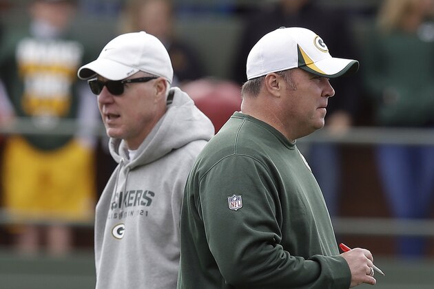 Green Bay Packers head coach Mike McCarthy talks to general manager Ted Thompson during NFL football training camp Sunday, July 28, 2013, in Green Bay, Wis. (AP Photo/Morry Gash)