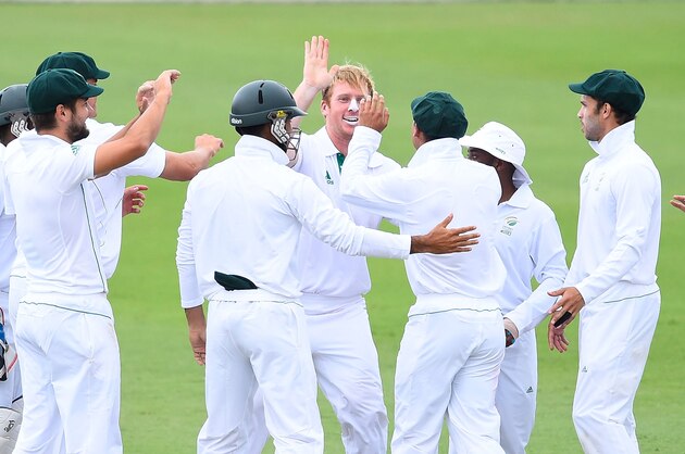 TOWNSVILLE, AUSTRALIA - AUGUST 09:  Simon Harmer (c) of South Africa 'A' celebrates the dimissal of Phil Hughes of Australia 'A' during the match between Australia 'A' and South Africa 'A' at Tony Ireland Stadium on August 9, 2014 in Townsville, Australia.  (Photo by Ian Hitchcock/Getty Images)