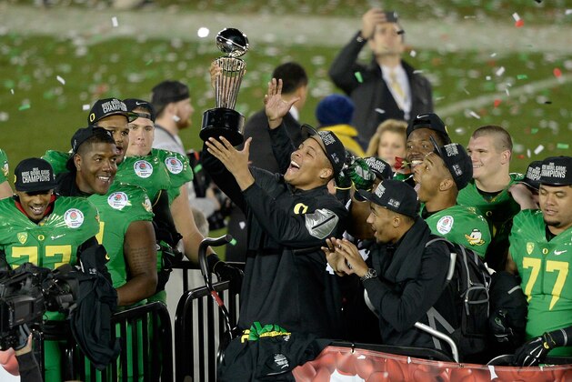 PASADENA, CA - JANUARY 01:  Defensive back Ifo Ekpre-Olomu #14 of the Oregon Ducks celebrates with the Leishman Trophy after defeating the Florida State Seminoles 59-20 in the College Football Playoff Semifinal at the Rose Bowl Game presented by Northwestern Mutual at the Rose Bowl on January 1, 2015 in Pasadena, California.  (Photo by Kevork Djansezian/Getty Images)