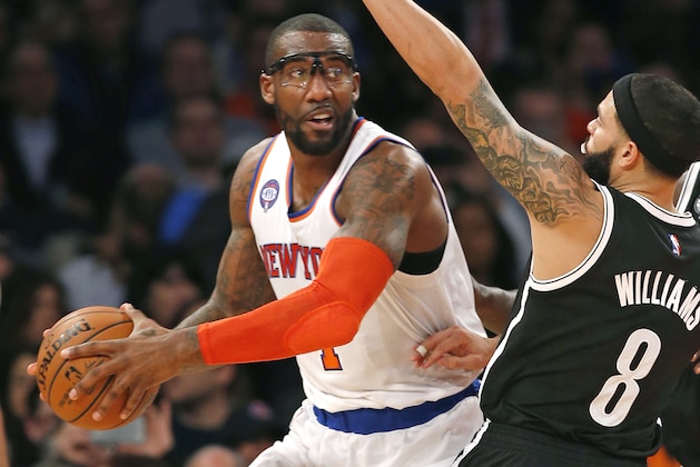 New York Knicks forward Amar'e Stoudemire (1) looks to pass with Brooklyn Nets guard Deron Williams (8) defending in the first half of an NBA basketball game at Madison Square Garden in New York, Tuesday, Dec. 2, 2014. (AP Photo/Kathy Willens)