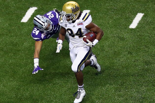 SAN ANTONIO, TX - JANUARY 02:  Paul Perkins #24 of the UCLA Bruins runs for a touchdown past Nate Jackson #24 of the Kansas State Wildcats in the second quarter during the Valero Alamo Bowl at Alamodome on January 2, 2015 in San Antonio, Texas.  (Photo by Ronald Martinez/Getty Images)