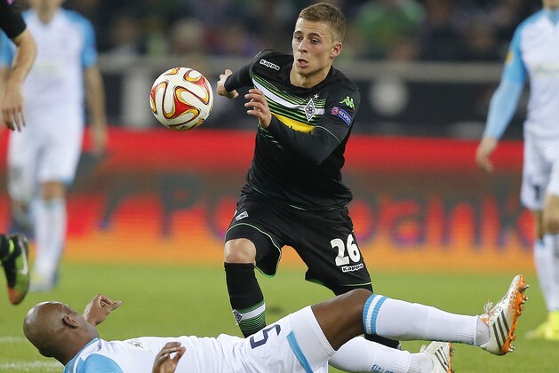 Moenchengladbach's Thorgan Hazard, rear, and Apollon’s Joao Paulo Andrade challenge for the ball during the Europa League group A soccer match between  Borussia Moenchengladbach and Apollon in Moenchengladbach, Germany, Thursday, Oct. 23, 2014 . (AP Photo/Frank Augstein)