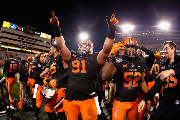 TEMPE, AZ - JANUARY 02:  Defensive tackle James Castleman #91 of the Oklahoma State Cowboys celebrates on the sidelines during the final moments of the TicketCity Cactus Bowl against the Washington Huskies at Sun Devil Stadium on January 2, 2015 in Tempe, Arizona. The Cowboys defeated the Huskies 30-22.  (Photo by Christian Petersen/Getty Images)