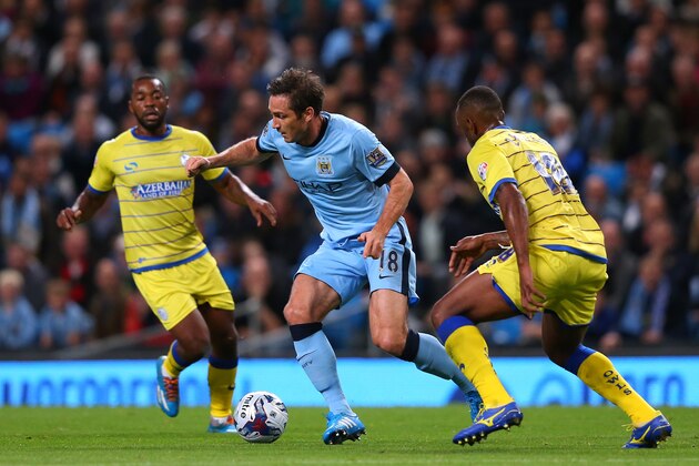 MANCHESTER, ENGLAND - SEPTEMBER 24:  Frank Lampard of Manchester City beats Kamil Zayatte of Sheffield Wednesday during the Capital One Cup Third Round match between Manchester City and Sheffield Wednesday at Etihad Stadium on September 24, 2014 in Manchester, England.  (Photo by Alex Livesey/Getty Images)