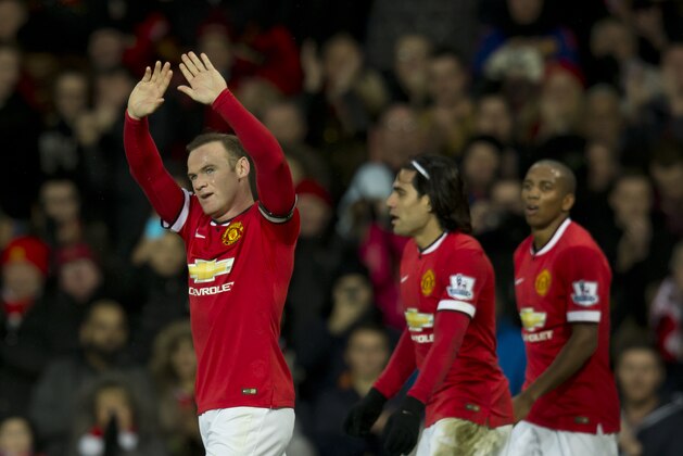 Manchester United's Wayne Rooney, left, celebrates after scoring his second goal during the English Premier League soccer match between Manchester United and Newcastle at Old Trafford Stadium, Manchester, England, Sunday Dec. 26, 2014. (AP Photo/Jon Super)