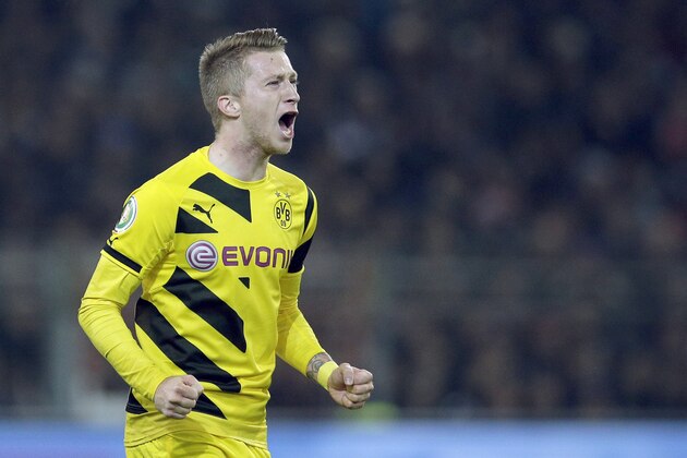 Dortmund's scorer Marco Reus shouts as he celebrates his side's second goal during the German soccer cup second round match between FC St. Pauli and Borussia Dortmund at the Millerntor Stadium in Hamburg, Germany, Tuesday, Oct. 28, 2014. (AP Photo/Michael Sohn)
