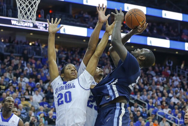 Jan 3, 2015; Newark, NJ, USA;  Villanova Wildcats forward JayVaughn Pinkston (22) attempts a shot over Seton Hall Pirates forward Desi Rodriguez (20) and forward Rashed Anthony (25) at the Prudential Center. Mandatory Credit: Jim O'Connor-USA TODAY Sports