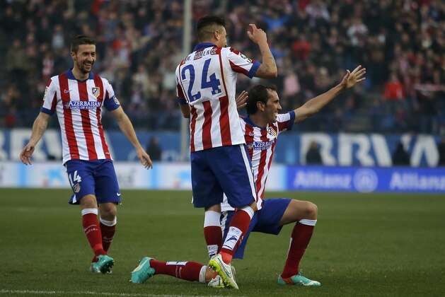 Atletico's Diego Godin, right, celebrates his goal with teammates during a Spanish La Liga soccer match between Atletico de Madrid and Levante at the Vicente Calderon stadium in Madrid, Spain, Saturday, Jan. 3, 2015. (AP Photo/Andres Kudacki)